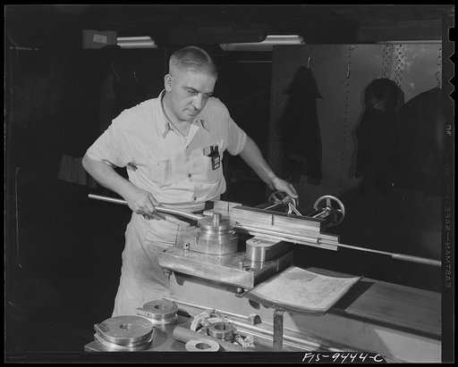 De Soto bomber plant. Detroit, Michigan. Worker at bending machine producing complex curves. The wires for the airplanes are inserted through these magnesium tubes
