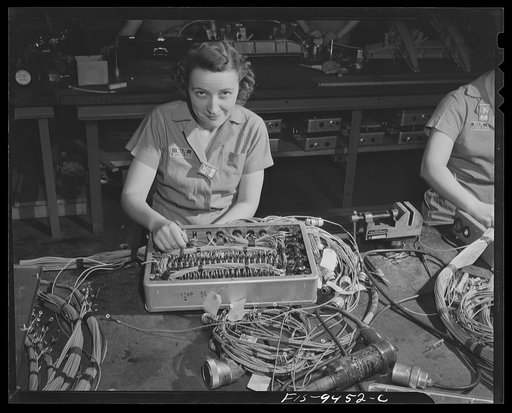 Untitled photo, possibly related to: De Soto bomber plant, Detroit, Michigan. Tables showing women workers assembling complex controll box