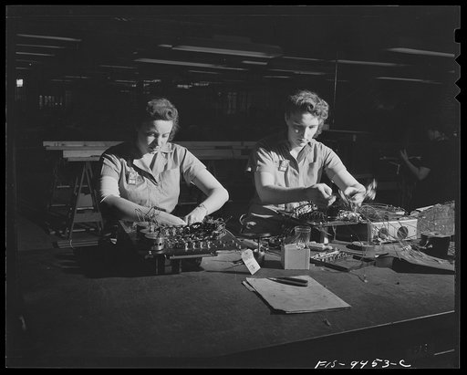 Untitled photo, possibly related to: De Soto bomber plant, Detroit, Michigan. Tables showing women workers assembling complex controll box