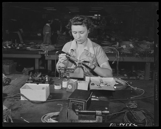 De Soto bomber plant, Detroit, Michigan. Woman worker soldering contact point on end of wire