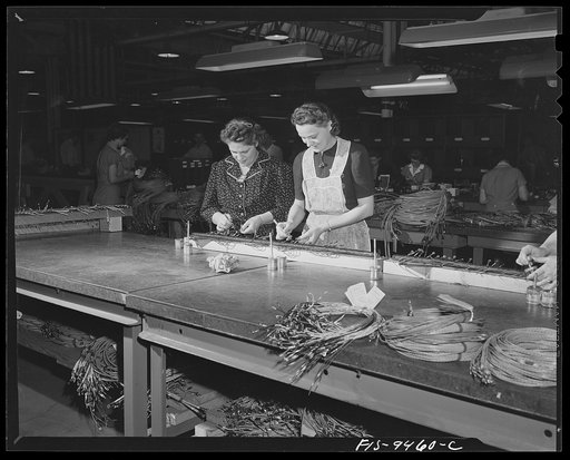 De Soto bomber plant, Detroit, Michigan. Putting eyelet contacts on ends of wires