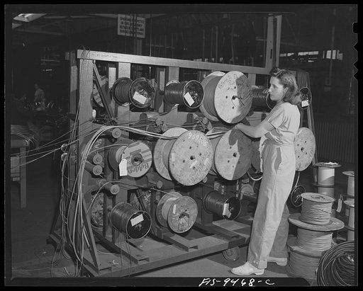 De Soto bomber plant. Detroit, Michigan. Woman worker and drums of various types of wire that are used for electrical connections throughout the bomber