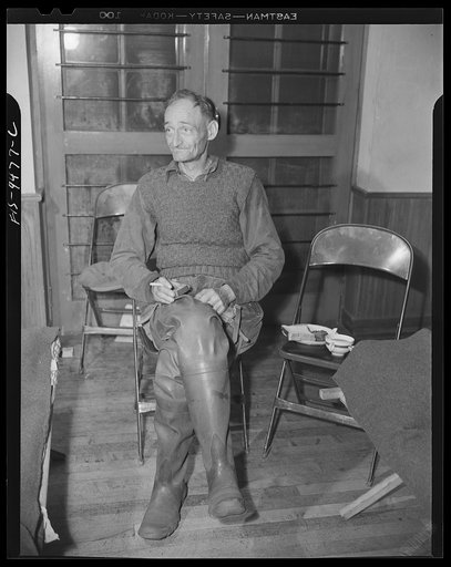 Washington, D.C. Man who was driven from his home by flood waters receiving hot coffee from an emergency canteen set up by the United States Office of Civilian Defense