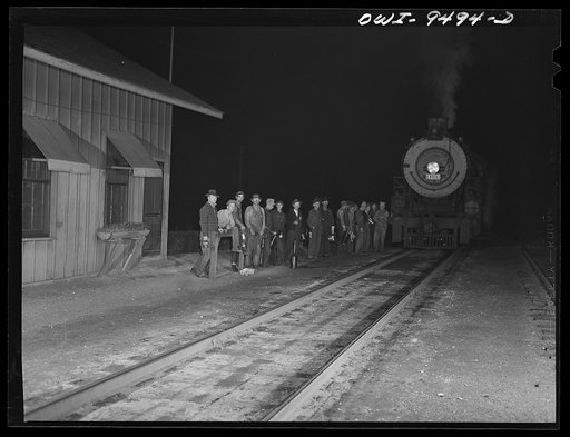 Tulsa, Oklahoma. Railroad men on the night shift in front of the station master's office