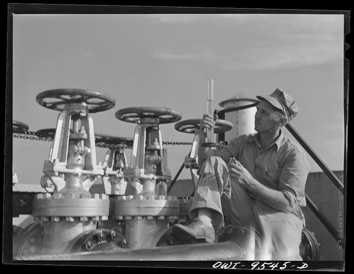 Untitled photo, possibly related to: Tulsa, Oklahoma. Examining a sample of gasoline taken from the flow at the Tulsa pumping station of the Great Lakes pipeline