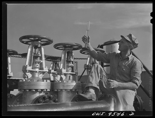 Untitled photo, possibly related to: Tulsa, Oklahoma. Examining a sample of gasoline taken from the flow at the Tulsa pumping station of the Great Lakes pipeline