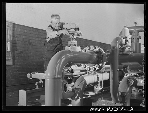 Tulsa, Oklahoma. Turning a valve in the pump room of the Tulsa station at the Great Lakes pipeline company