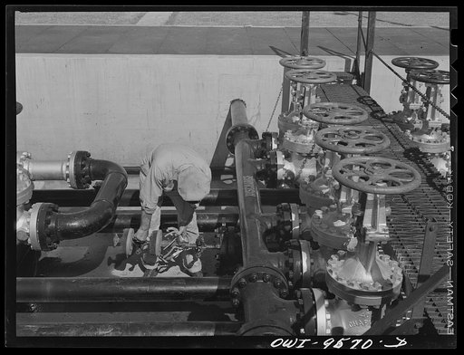 Tulsa, Oklahoma. Putting "scraper" or "go-devil", a cleaning apparatus, into the pipe at the pumping station of the Great Lakes pipeline to send it up to the Barnsdall station, fifty miles north