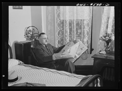 Butte, Montana. John Herlihy, a shift boss at the Mountain Con mine, reading a newspaper at home