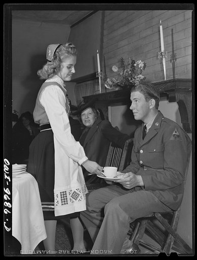 Butte, Montana. Girl in Norwegian costume serving tea to a serviceman at the Little Norway Knitting Club silver tea