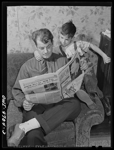 Butte, Montana. Victor Rauh and one of his children reading a newspaper