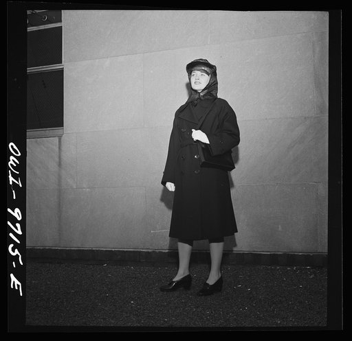 New York, New York. A Powers Agency model on the roof of third Naval district headquarters at 90 Church Street, dressed in a WAVE's (Women Auxiliary Volunteer Emergency Service) rain outfit
