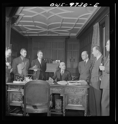 Untitled photo, possibly related to: Washington, D.C. The Turkish Embassy. Ambassador Ertrogren [i.e., Ertegun] and his staff in his office