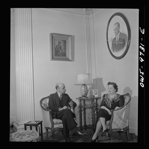 Washington, D.C. The Turkish Embassy. Ambassador and Madame Ertrogren [i.e., Ertegun] in the embassy living room. Photograph of Mustapha Kemal above Madame's head
