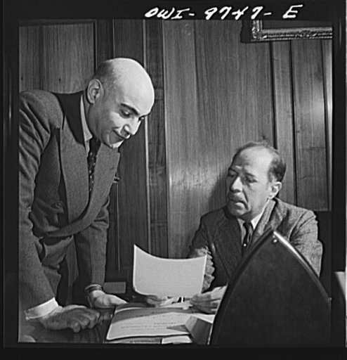 Washington, D.C. The Egyptian Legation on Massachusetts Avenue. Mahmoud Hassan, minister from Egypt, conferring with a member of his staff