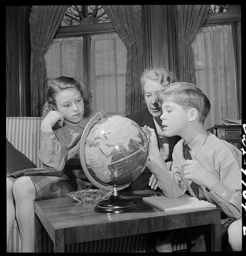 Washington, D.C. The Australian Legation. Mrs. Casey, wife of the minister, examining a globe with her son and daughter