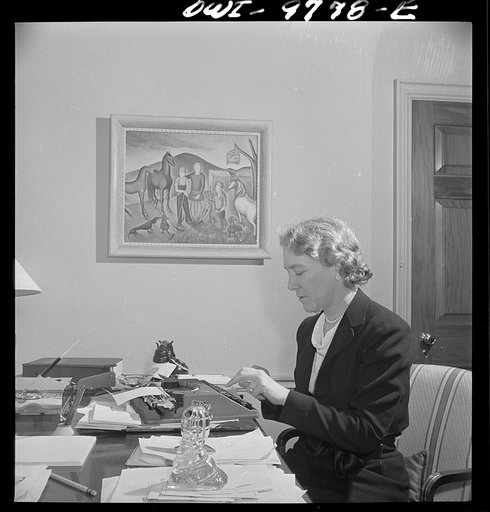 Washington, D.C. The Australian Legation. Mrs. Casey, wife of the minister, learns typing in her spare time. She painted the picture on the wall which depicts her family at their Australian farm