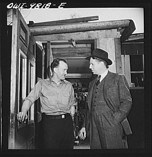 Passaic, New Jersey. Factory owner Carlson organized home machine shops for defense work. Carlson visiting one of the home workshop owners. Both men are of Sweedish origin