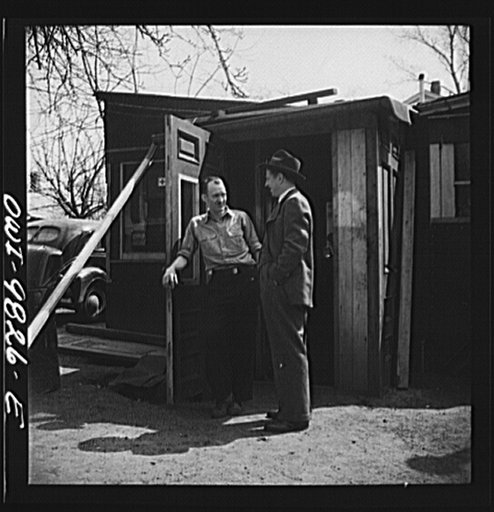 Passaic, New Jersey. Factory owner Carlson organized home machine shops for defense work. Carlson visiting one of the home workshop owners in the bach yard. Both men are of Sweedish origin