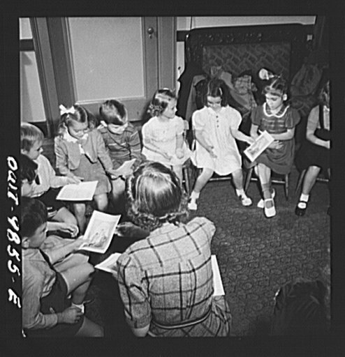 New York, New York. Janet and Marie (age six, second from right) Wynn [or Winn] attend Sunday school in the Jan Huss Church on East Seventy-third Street. Although most of the students and teachers are Czech-American, they conduct school in English. Marie's class receiving illustrations of the Bible 