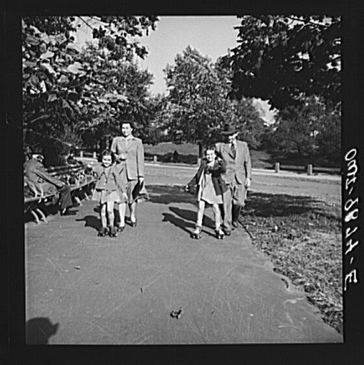Untitled photo, possibly related to: New York, New York. Janet and Marie, Czech-American children, roller-skating in Central Park. Dr. and Mrs. Winn [or Wynn] are walking behind