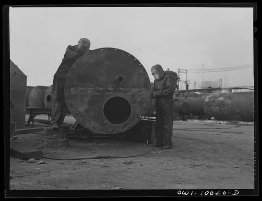 Tulsa, Oklahoma. Welders at work on a tank being made from salvaged material at the Mid-continent refinery