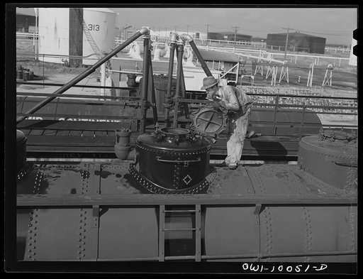 Tulsa, Oklahoma. Worker taking the top off a tank car preparatory to loading it at the Mid-continent refinery