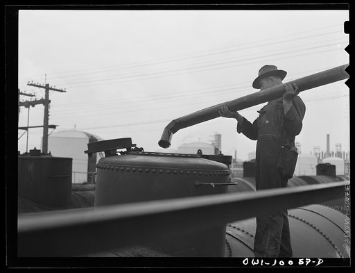 Untitled photo, possibly related to: Tulsa, Oklahoma. Placing a spout in a tank car preparatory to laoding it at the Mid-continent refinery