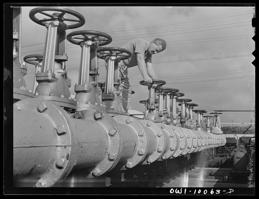 Tulsa, Oklahoma. Operating valve in manifold which controls the pipeline system at the Mid-continent refinery
