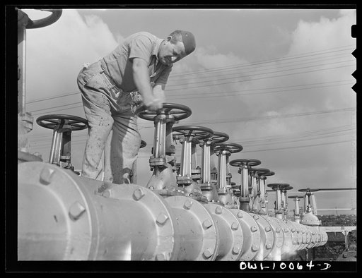 Tulsa, Oklahoma. Operating valve in manifold which controls the pipeline system at the Mid-continent refinery