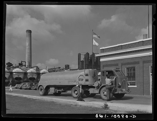 Tulsa, Oklahoma. Guard checking out a truck and driver leaving the grounds at the Mid-continent refinery