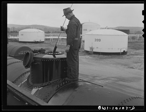Tulsa, Oklahoma. Using a "thief" to obtain samples of gasoline after loading the tank car at the Mid-continent refinery