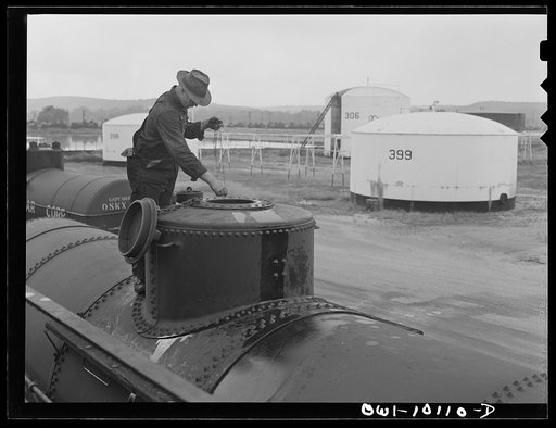 Tulsa, Oklahoma. Taking a sample of gasoline from a tank car just loaded at the Mid-continent refinery