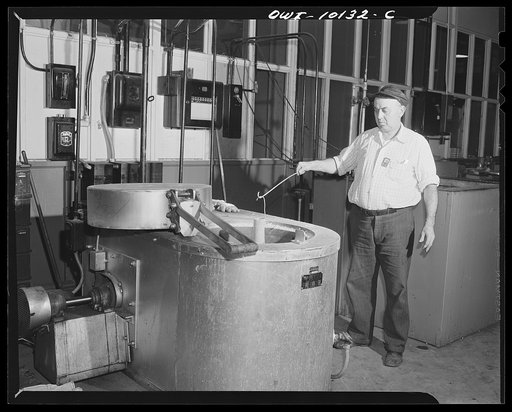 De Soto bomber plant. Detroit, Michigan. Workmen taking a rivet container out of a heat treating furnace. From here they are put into an icebox until used, when they expand to form an extremely tight joint