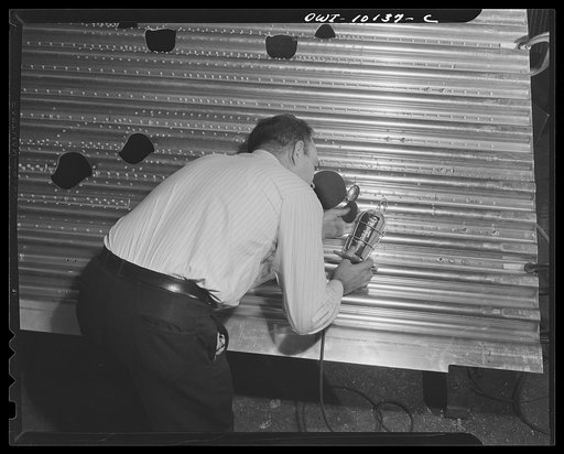 De Soto bomber plant. Detroit, Michigan. Each rivet is inspected with a magnifying glass