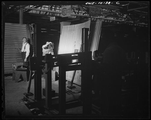 Untitled photo, possibly related to: De Soto bomber plant. Detroit, Michigan. Each rivet is inspected with a magnifying glass