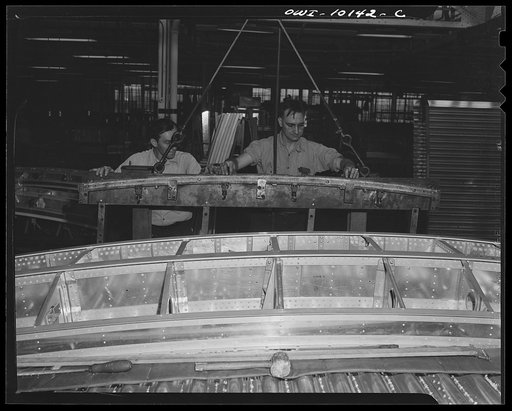 De Soto bomber plant. Detroit, Michigan. This picture shows a fixture being loaded with a central wing assembly