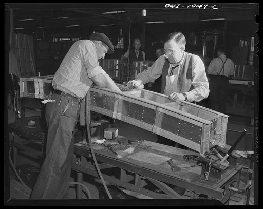 De Soto bomber plant. Detroit, Michigan. Two inspectors with a bomb rack support beam