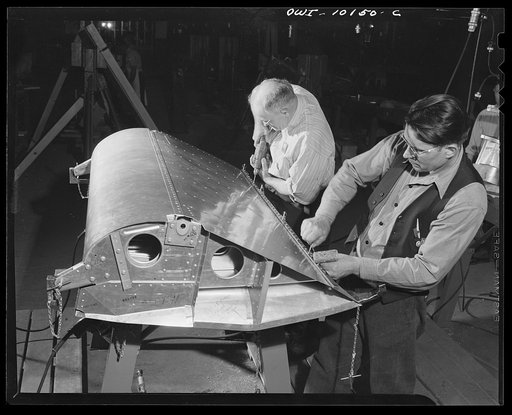 De Soto bomber plant. Detroit, Michigan. Drilling holes for the rivets on the leading edge fillet which is the edge of the wing flap