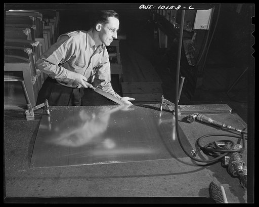 De Soto bomber plant, Detroit, Michigan. Using file for finishing touches on skin for side panel