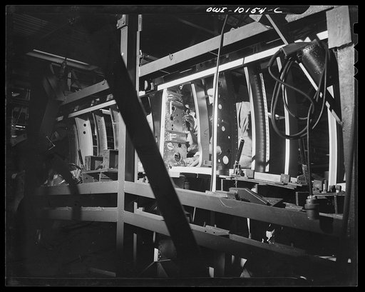 Untitled photo, possibly related to: De Soto bomber plant. Detroit, Michigan. Drilling on a side assembly