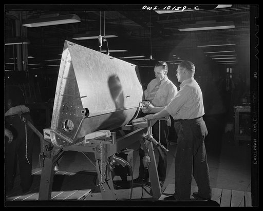 De Soto bomber plant, Detroit, Michigan. Clecoing skin to the ribs of an inboard flap