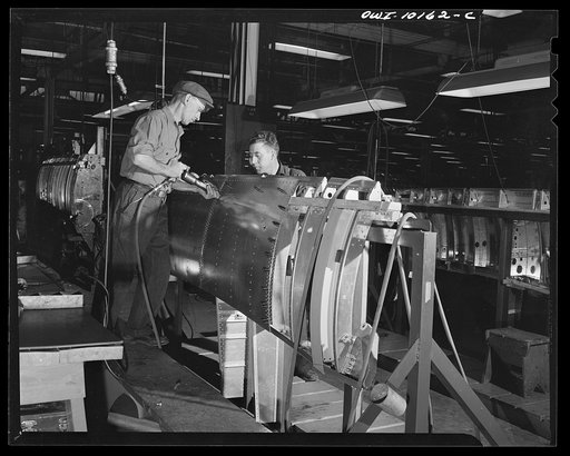 De Soto bomber plant, Detroit, Michigan. Riveting skin to the side panel