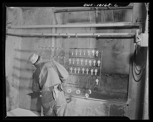 De Soto bomber plant, Detroit, Michigan. Spraying tie bar ends