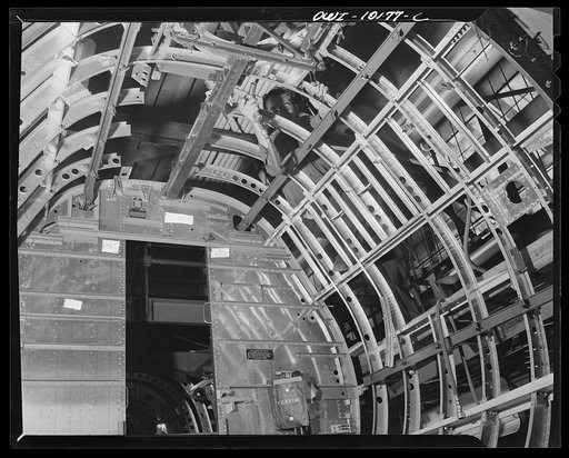 De Soto bomber plant, Detroit, Michigan. Installation of the navigator turret ring in a nose section