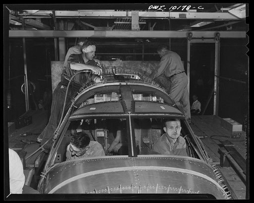 Untitled photo, possibly related to: De Soto bomber plant, Detroit, Michigan. Final operation in major assembly fixture of the nose section