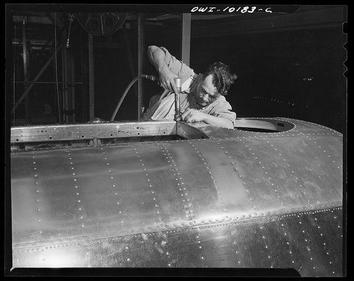 De Soto bomber plant, Detroit, Michigan. Final riveting operation on the life raft opening