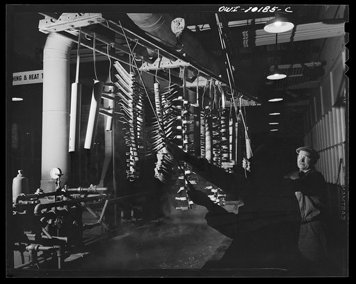 Untitled photo, possibly related to: De Soto bomber plant, Detroit, Michigan. Dipping parts that are held by the springs in a plating solution