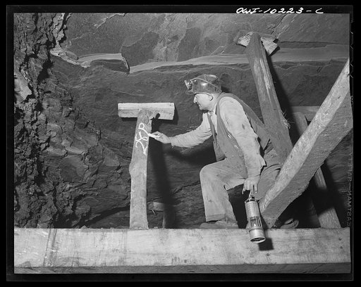 Pittsburgh, Pennsylvania (vicinity). Montour no. 4 mine of the Pittsburgh Coal Company. Testing for gas with a safety lamp; of there is gas, the lamp will burn with a blue flame. The screening keeps the open flame confined but lets the gas in