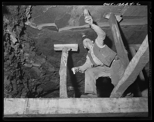 Pittsburgh, Pennsylvania (vicinity). Montour no. 4 mine of the Pittsburgh Coal Company. Testing for gas with a safety lamp; of there is gas, the lamp will burn with a blue flame. The screening keeps the open flame confined but lets the gas in